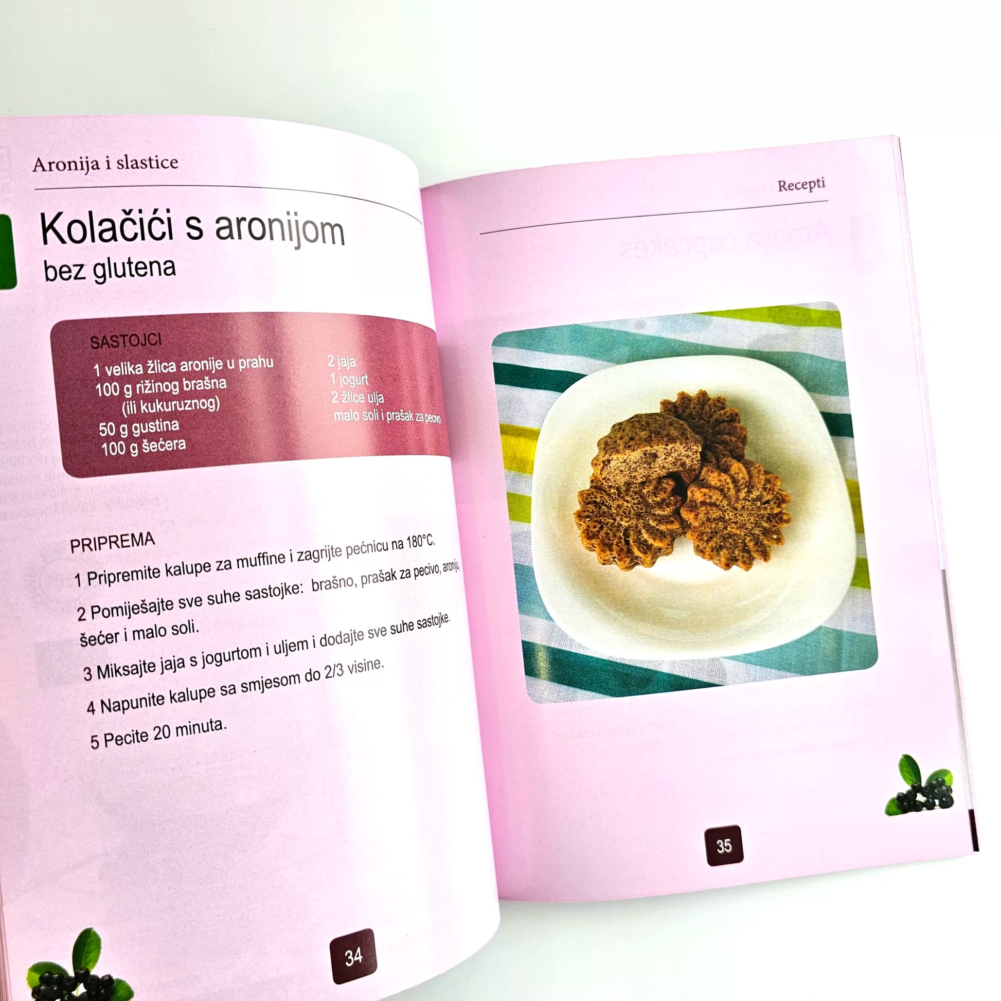 Aronija i Slastice (Aronia Desserts) Open cookbook showing a recipe for cookies with aronia berries on a white background