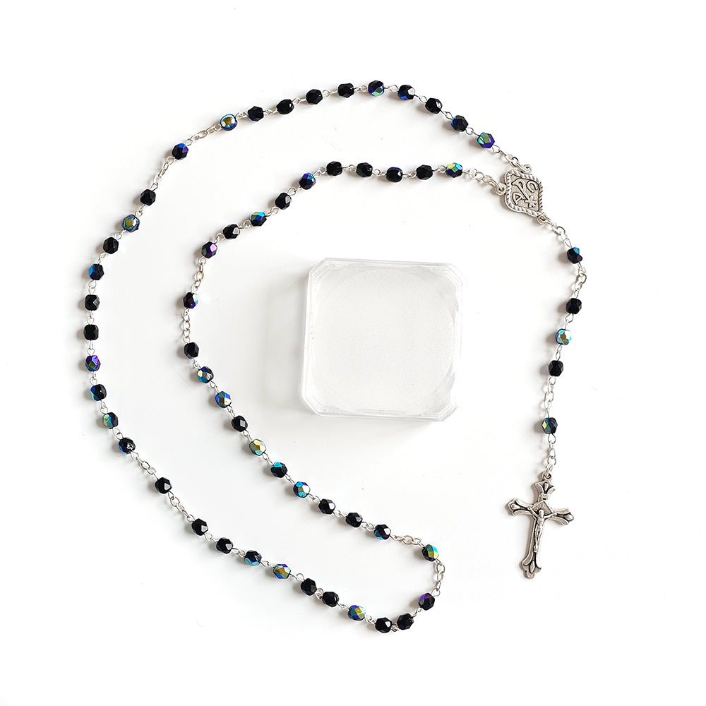 Black Crystal Catholic Rosary with Silver Crucifix and Alpha Omega Centerpiece Rosary with black beads and a cross on a white background