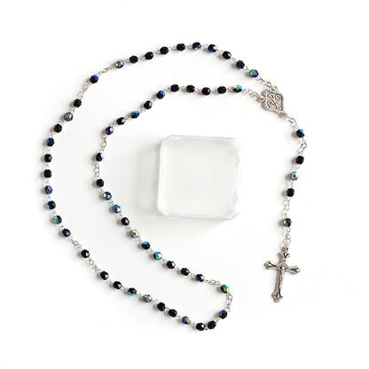 Black Crystal Catholic Rosary with Silver Crucifix and Alpha Omega Centerpiece Rosary with black beads and a cross on a white background