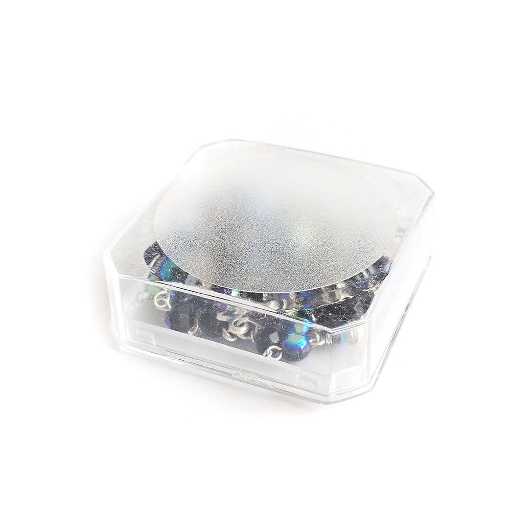 Black Crystal Catholic Rosary with Silver Crucifix and Alpha Omega Centerpiece Clear plastic container with a reflective lid on a white background