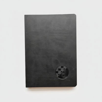 Black notebook with a circular logo on a white background