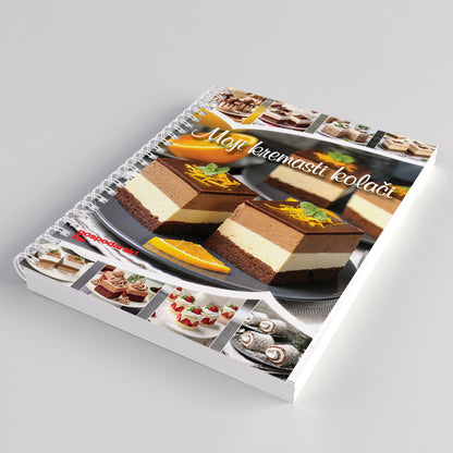 Moji Kremasti KOLAČI Spiral-bound notebook with dessert images and text on a gray background